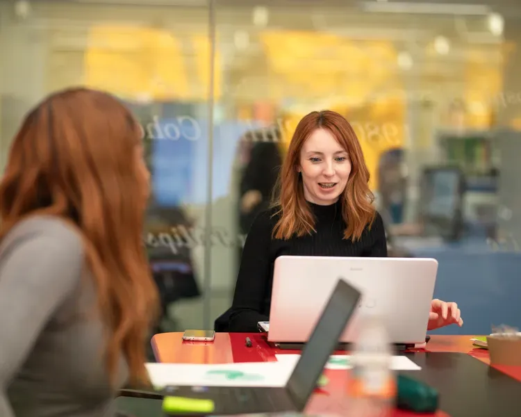 students in front of a laptop screen