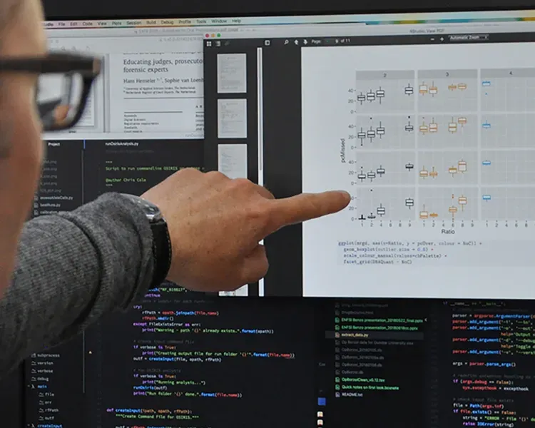 a man pointing to data on a computer screen