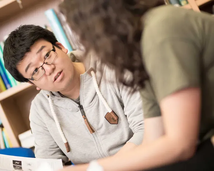 Students looking over paper work