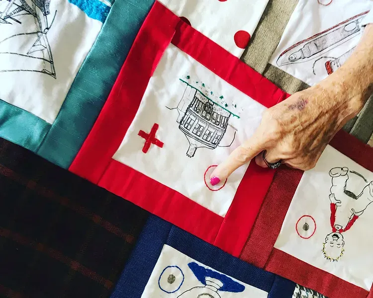 hand of older woman pointing to textile