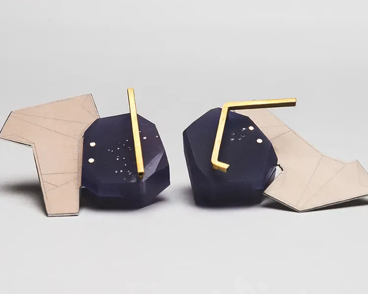 Blue earrings on a grey background