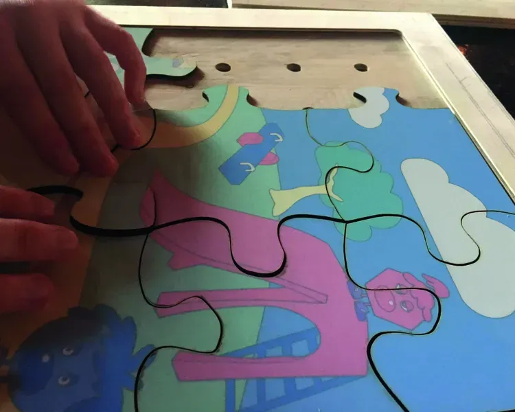 brightly coloured jigsaw in wooden tray