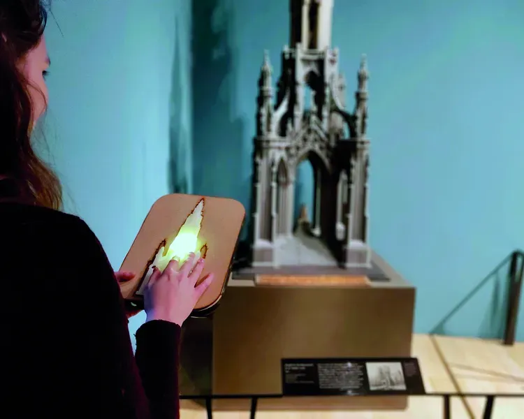 a person drawing a model of a monument