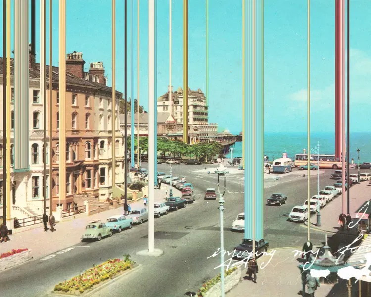 an image of a road with cars and houses