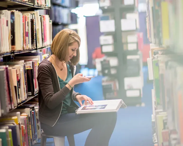 student in library