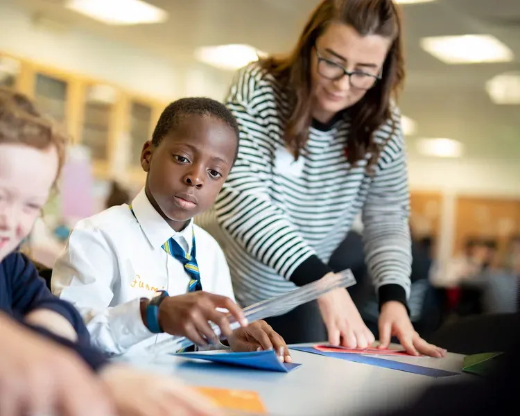 Student helping school pupils