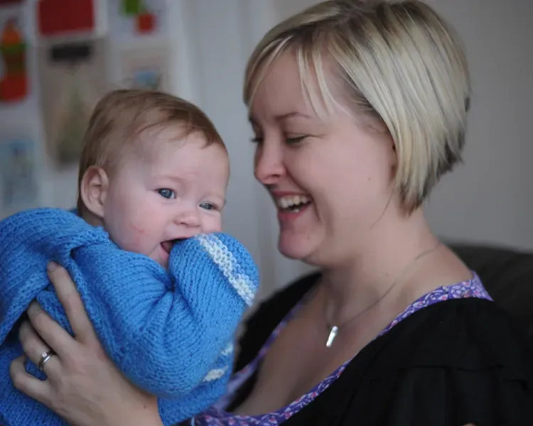 a mother holding her baby