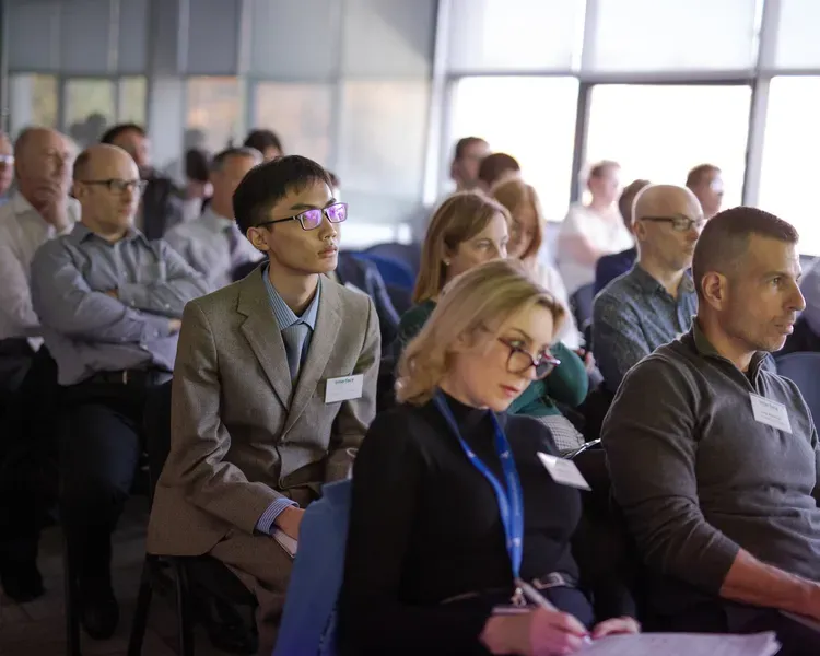 people sitting in rows in a conference room