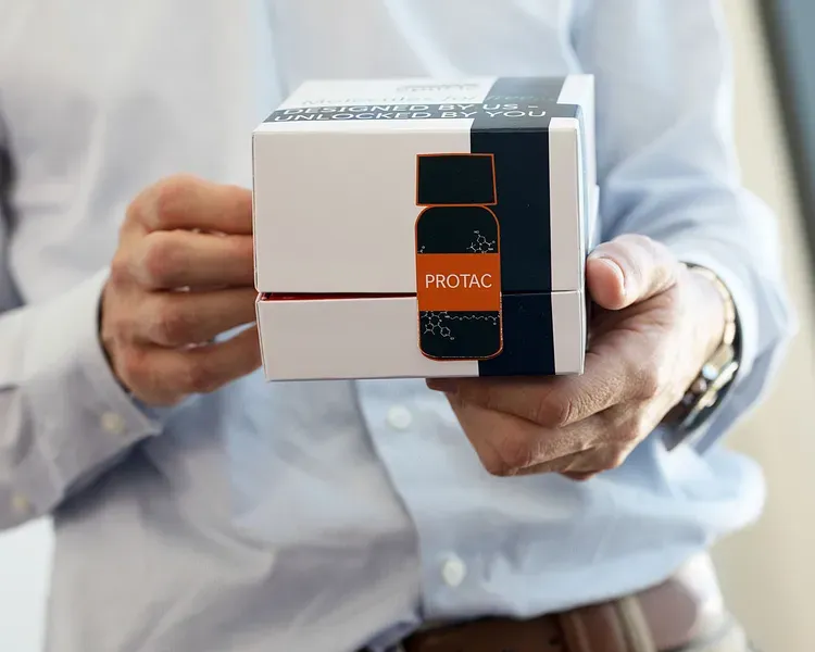 Researcher holding PROTAC box