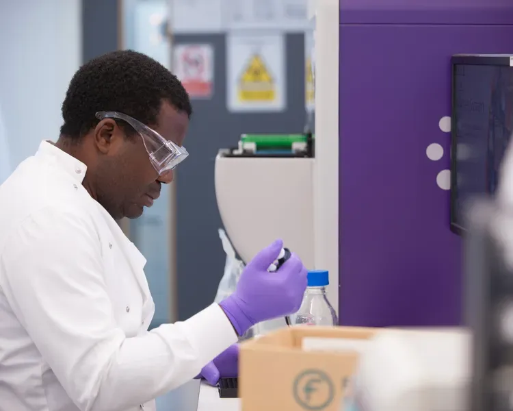 scientist in lab holding a syringe