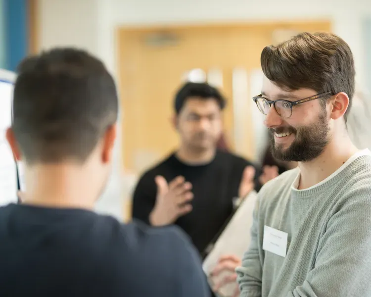 two men chatting near a scientific poster