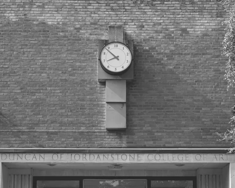 black and white image of clock with only ten hours