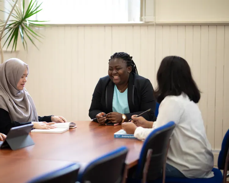 A group of students sitting round a table