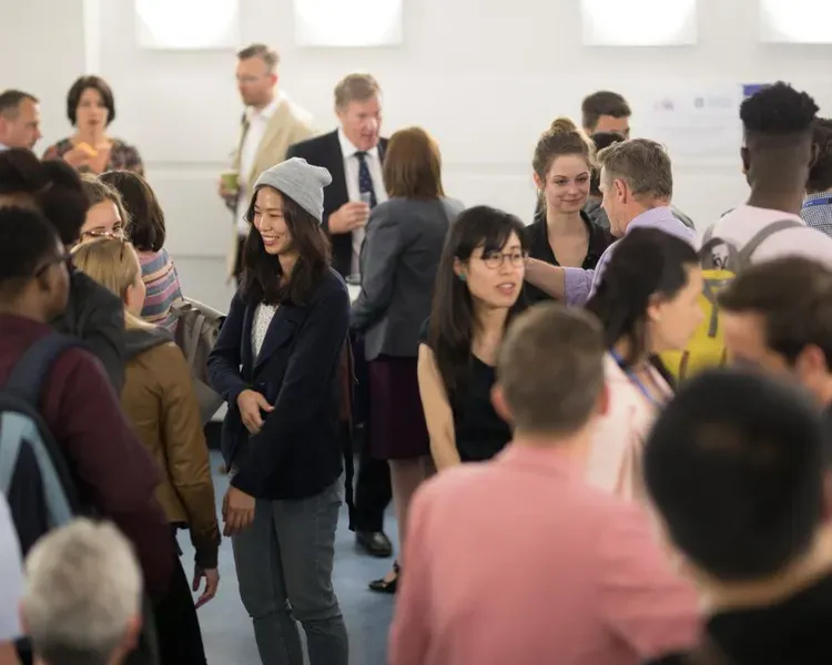 A group of alumni and students gather