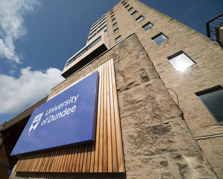 Tower Building with the University of Dundee logo and blue skies above