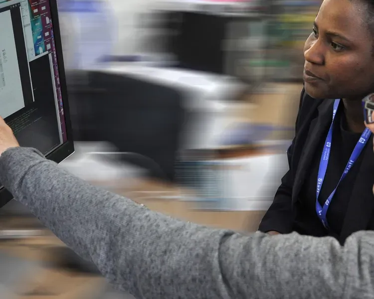 Two researchers looking at a computer screen