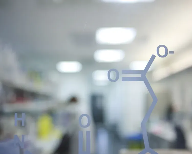 molecule painted on glass wall in front of a blurred out lab
