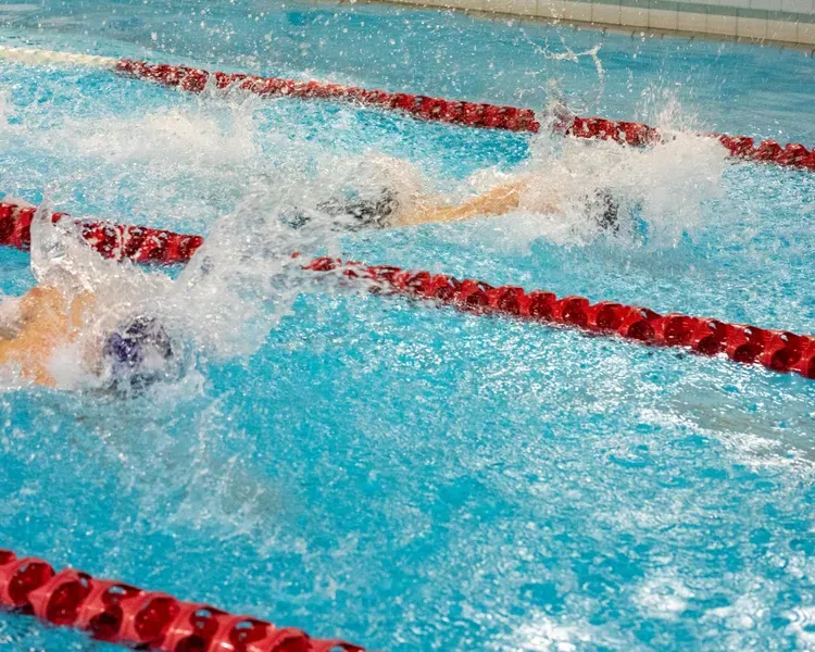student swimming between lanes