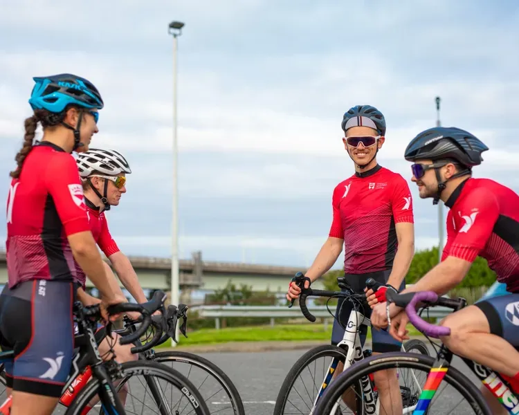 students in red kit on bikes