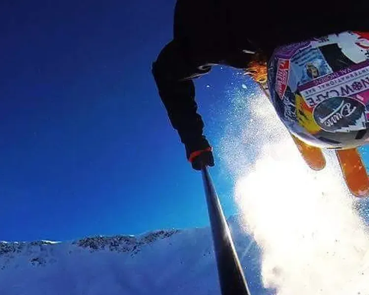 Skier doing a somersault over a snow covered mountain