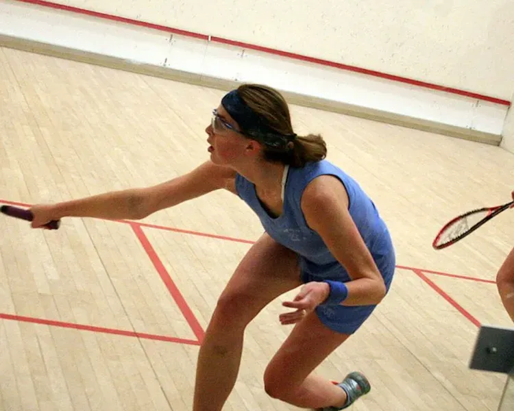 two women playing squash