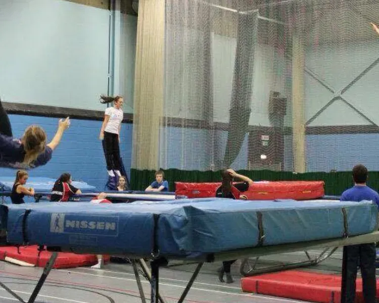 Girl doing a back flip on a trampoline