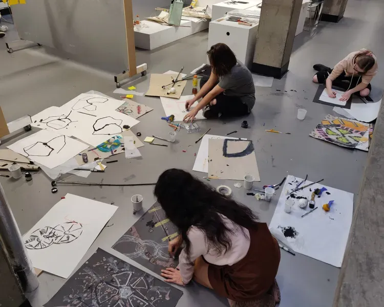 students painting on the floor