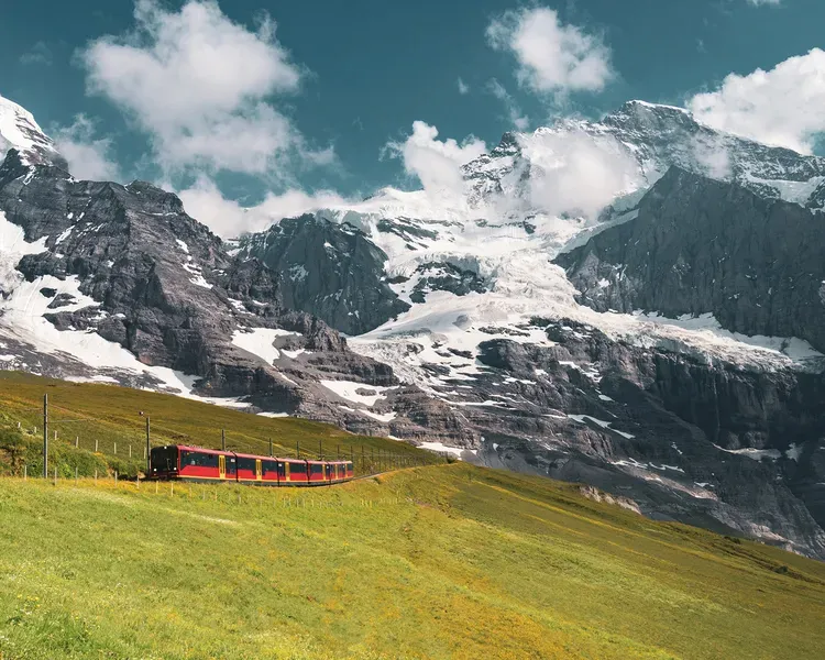 Train ascending snowy mountains