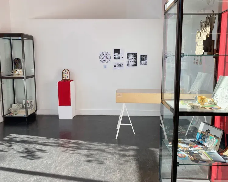 Archive Illustration Exhibition Space 2022 showing glass display cabinets filled with drawings and books