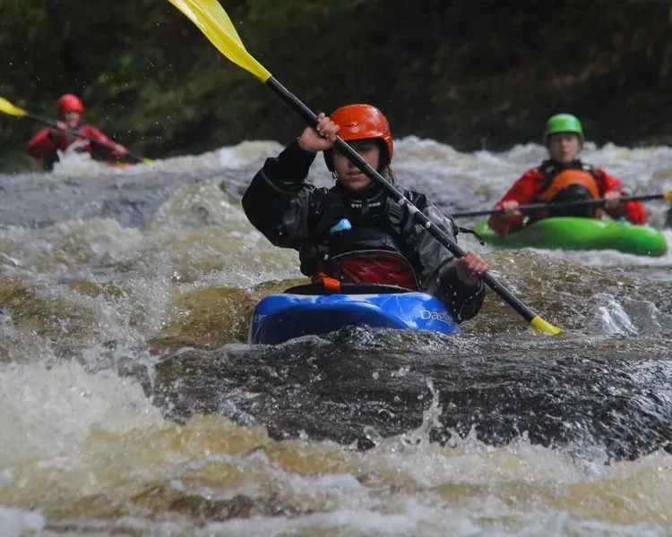 Canoe going over rapids