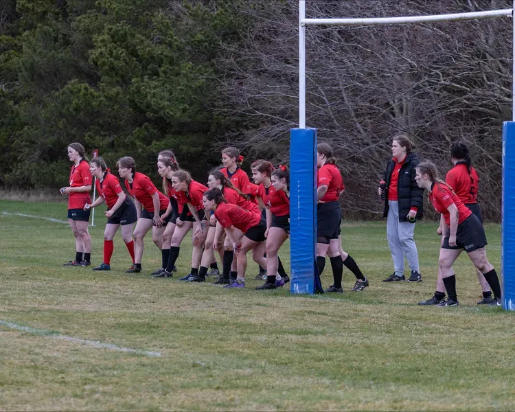 A group of women rugby players getting ready to run onto the field