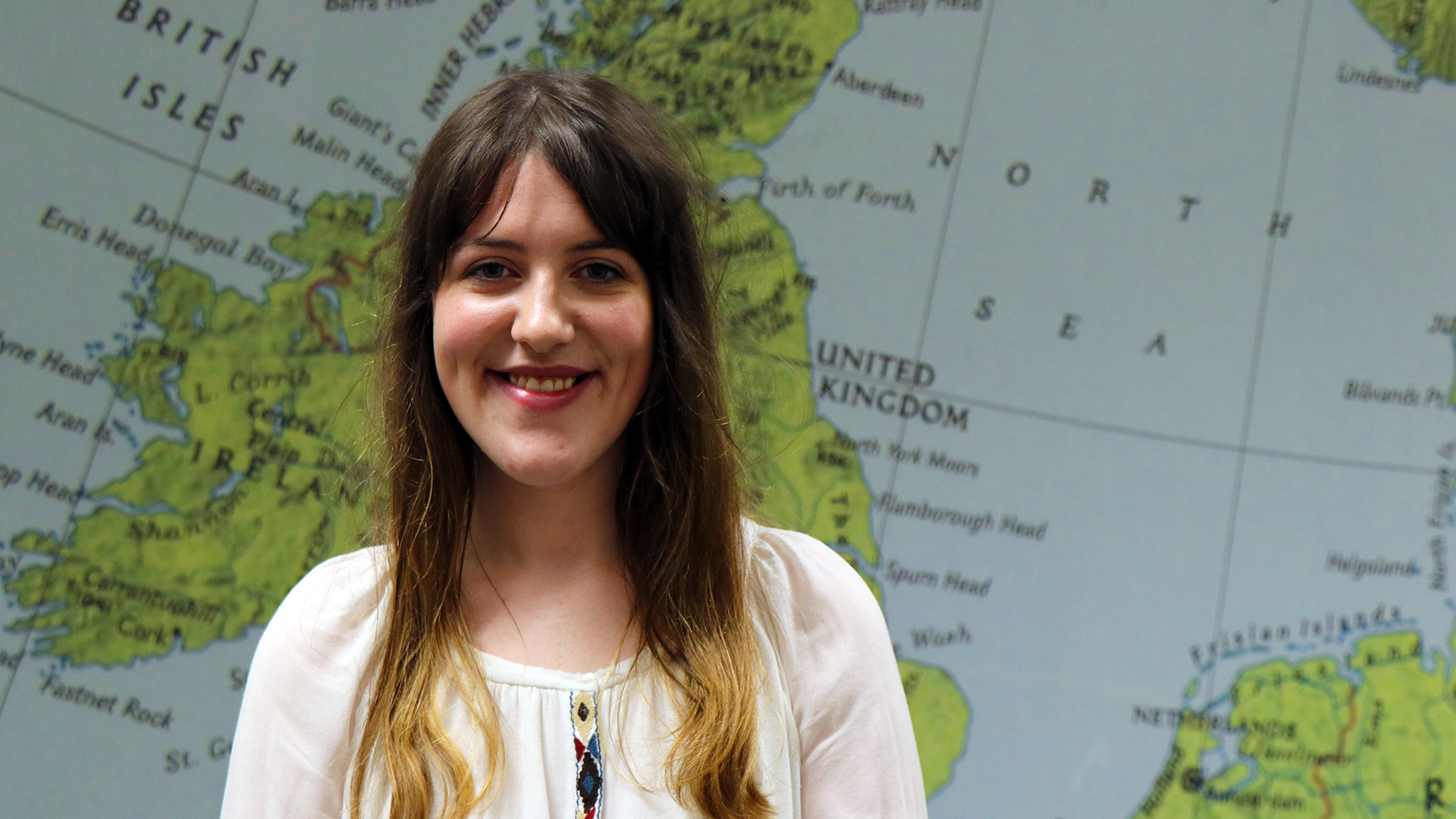 a student in front of a map