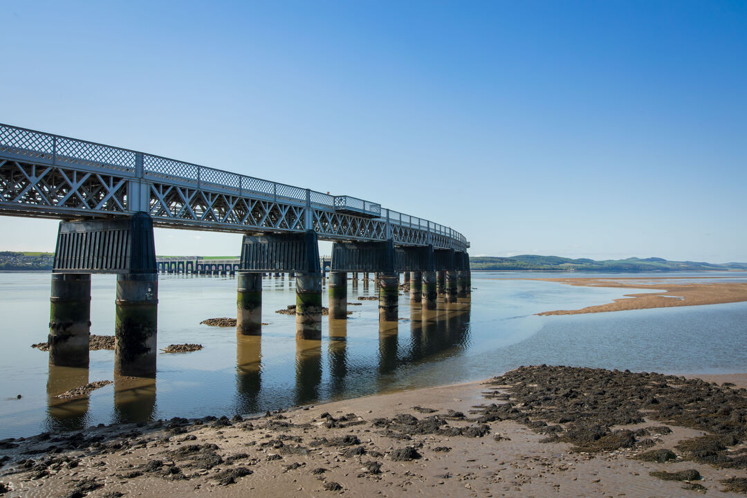 Tay Bridge on a sunny day with sandy shore nearby