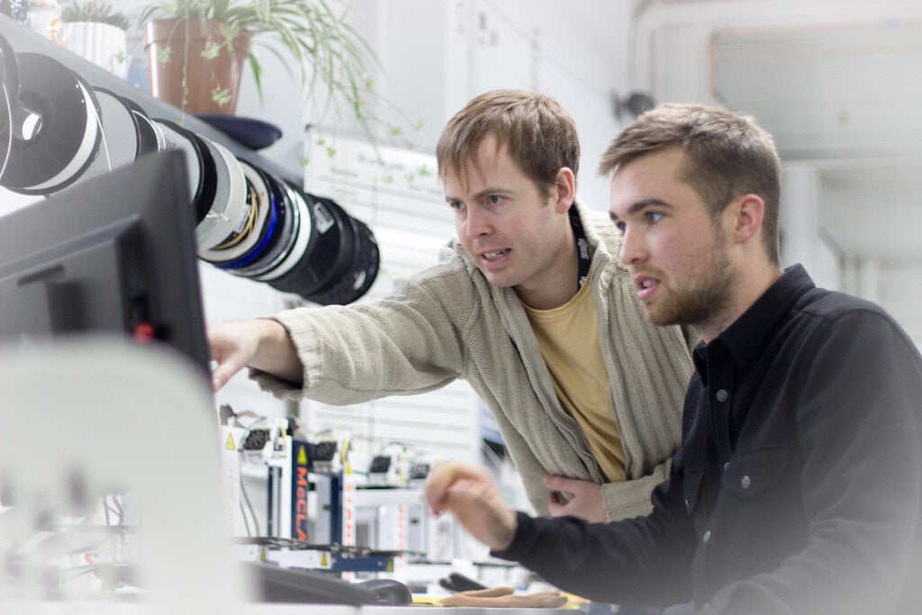 students looking through magnifying equipment