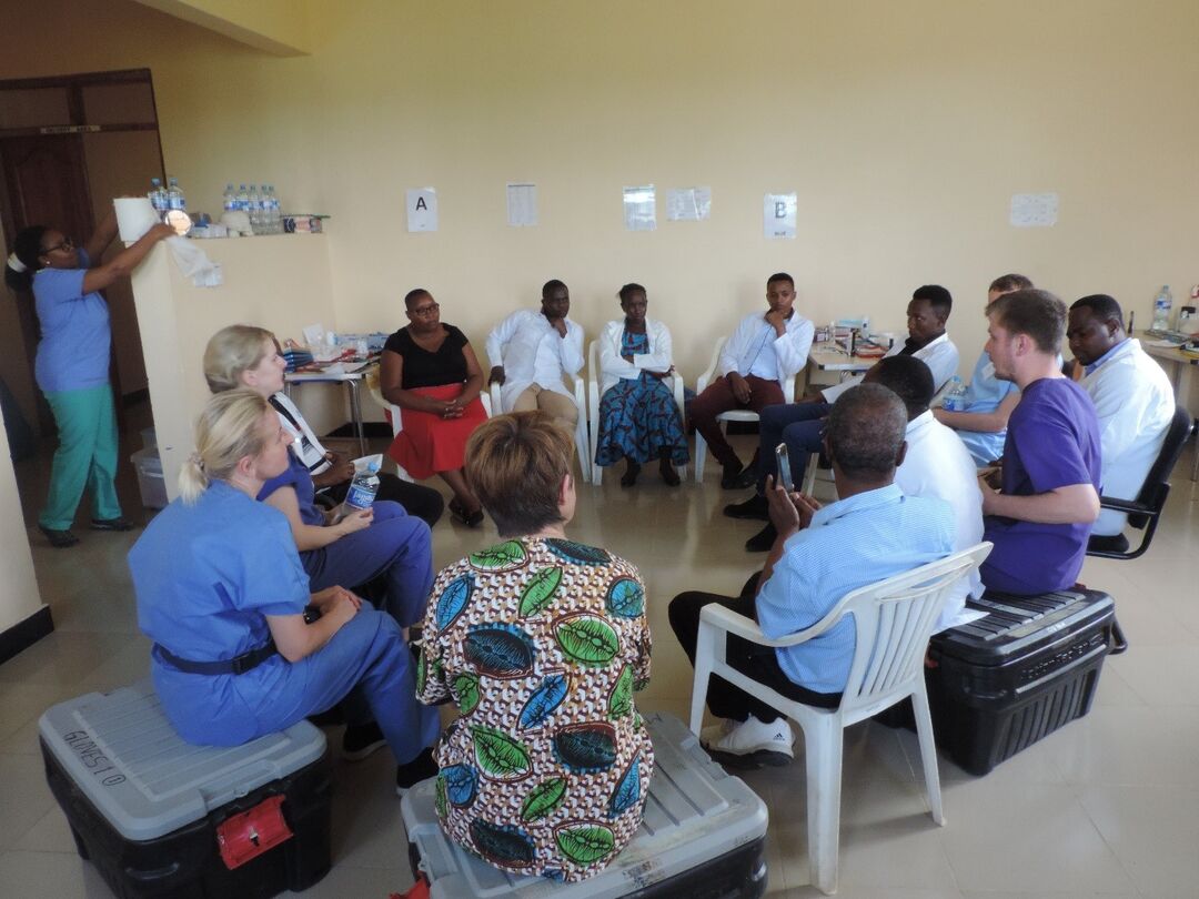 a group pf people sitting on chairs in a circle