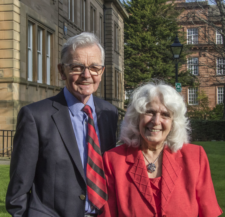 a man and a woman standing smiling