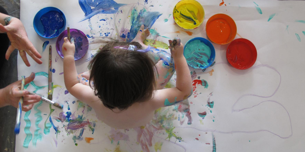 child engaging with art, shown from above