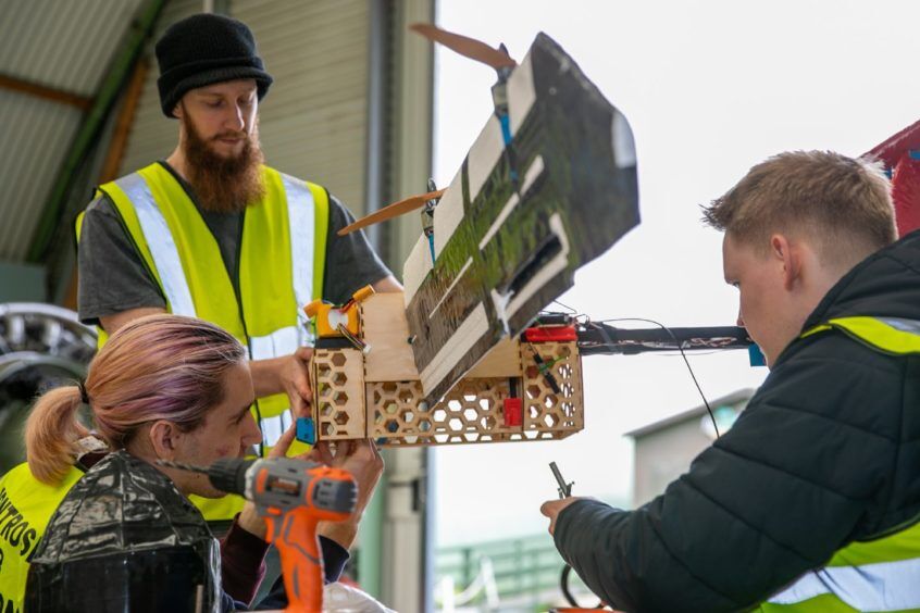 3 students working on the model