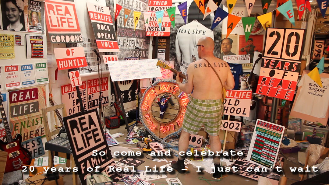 man in shorts in room with many posters