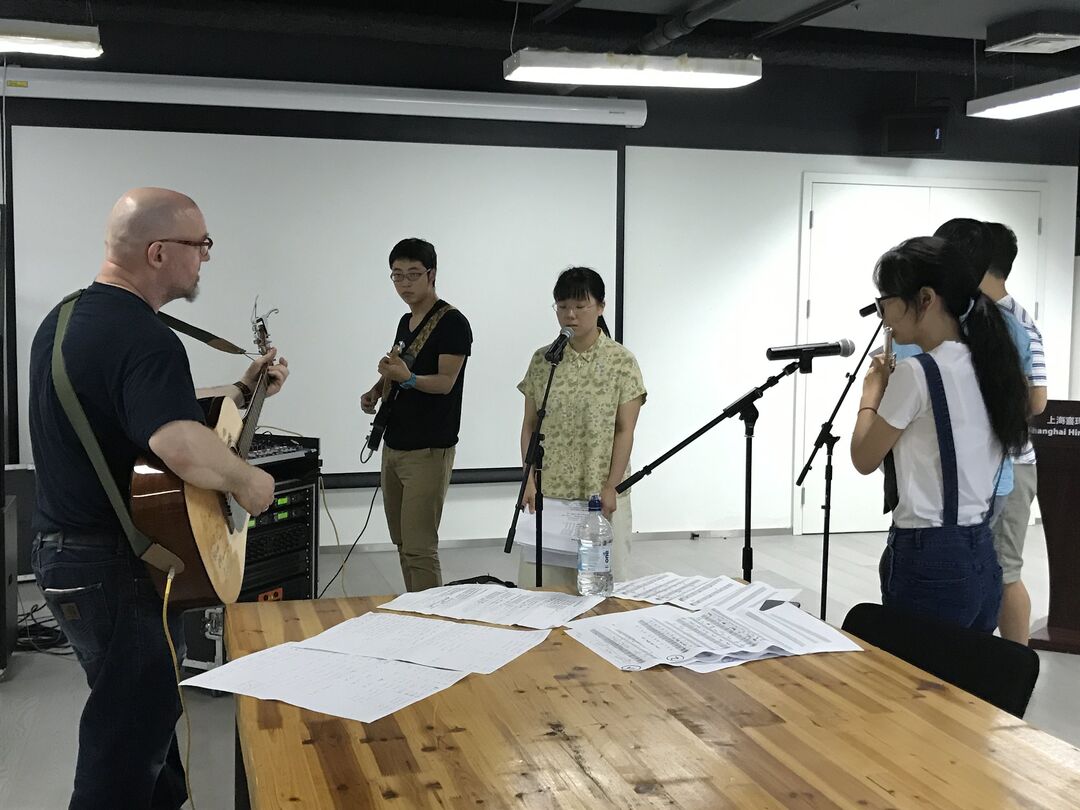 Ross Sinclair rehearsing with members of The Chinese-Scottish Real Life Orchestra.