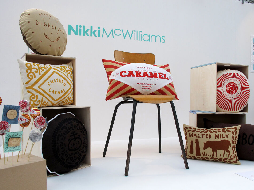 a display at the London trade show with various cushions on display