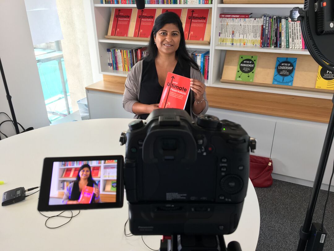 A camera records Jay speaking about her book