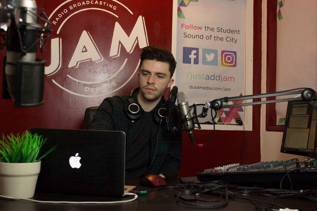 Lewis Kennedy sitting in the Jam Radio studio on city campus 