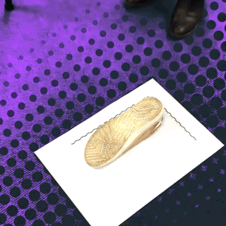 Animated gif of person setting up camera tripod