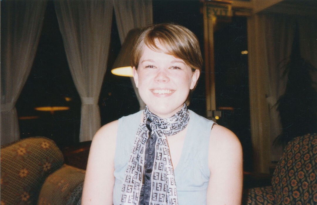 Sheryl Bartlett sits in a soft lit room, with bright light on her face.