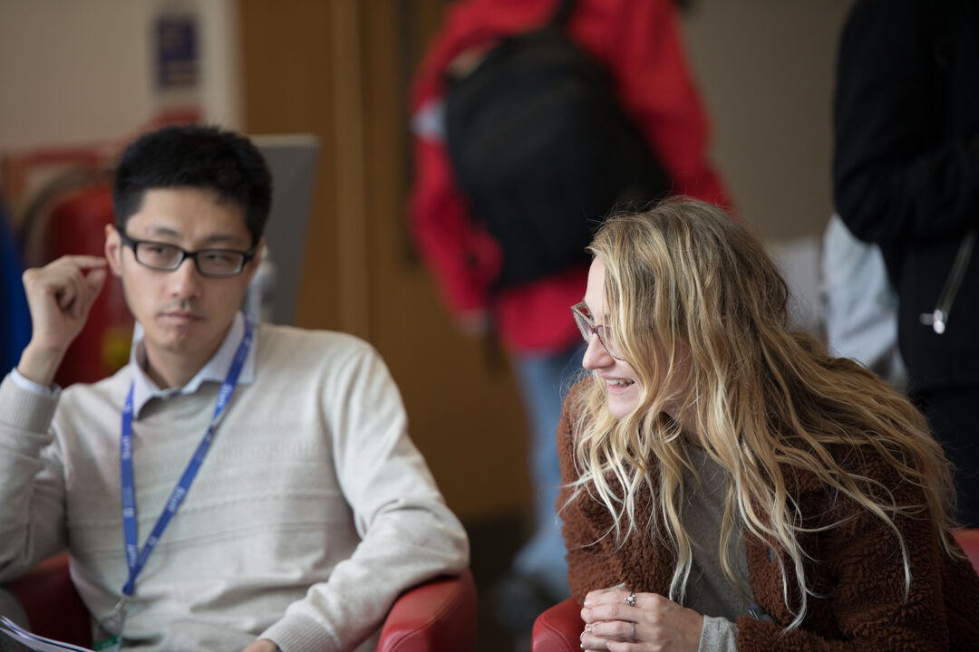 Staff in conversation at a conference