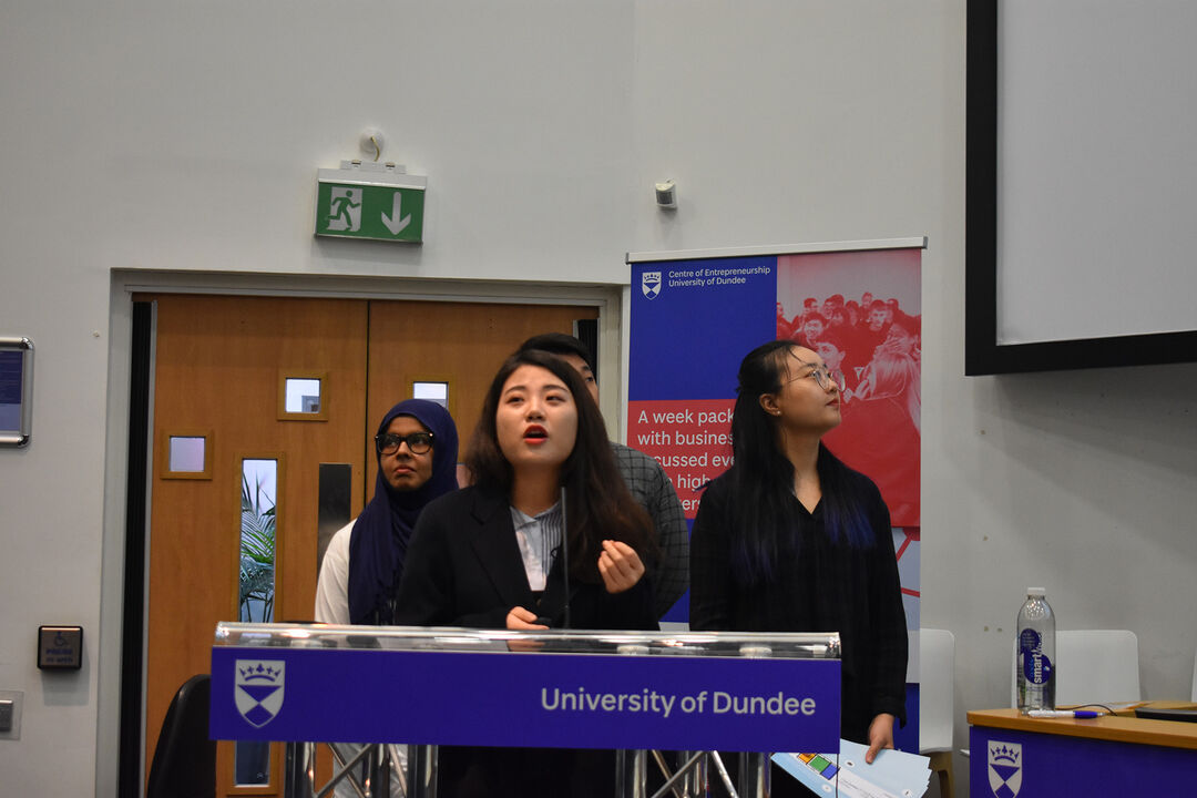 A group called Health Alliance speaking at the Venture 2019 final competition giving their presentation
