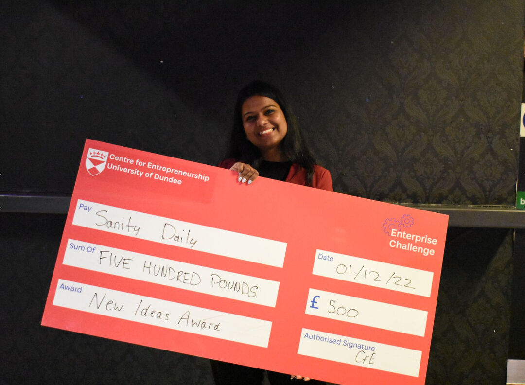 The runner up winner of the New Ideas award holding an oversized cheque showing the value of  £500