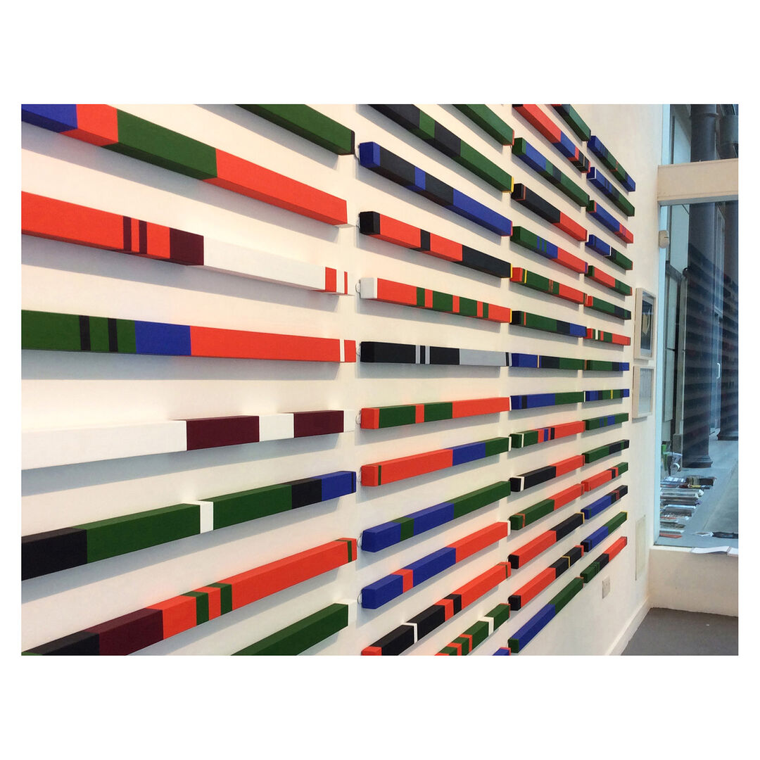 An exhibition wall showing several tartans 