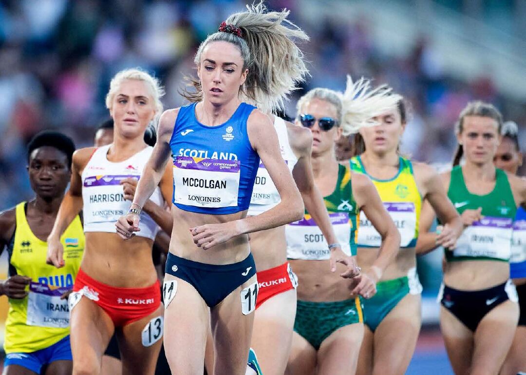 Eilish McColgan running in front of a group of people in the women's 10,000m race
